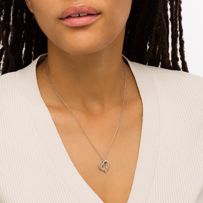 Main Image 2 of 1/8 CT. T.W.  Diamond Tilted Double Row Heart Pendant in Sterling Silver
