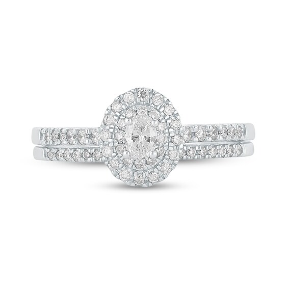 1/2 CT. T.w. Oval Diamond Frame Bridal Set in 10K White Gold