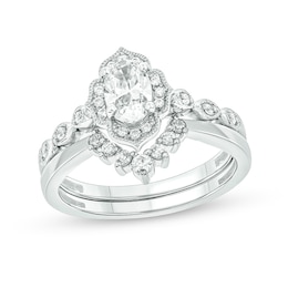 3/4 CT. T.W. Oval Diamond Frame Vintage-Style Bridal Set in 14K White Gold (I/I2)