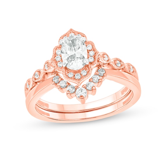 3/4 CT. T.w. Oval Diamond Frame Vintage-Style Bridal Set in 14K Rose Gold (I/I2)