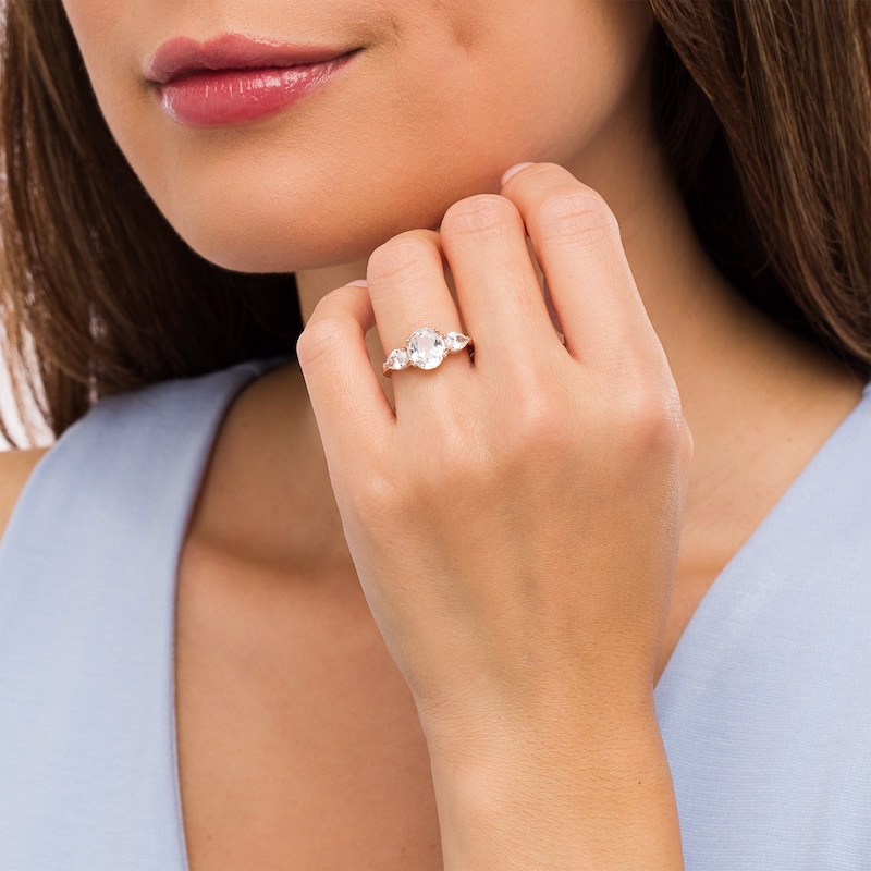 Main Image 2 of Oval White Lab-Created Sapphire and 1/6 CT. T.W. Diamond Frame Three Stone Engagement Ring in 10K Rose Gold