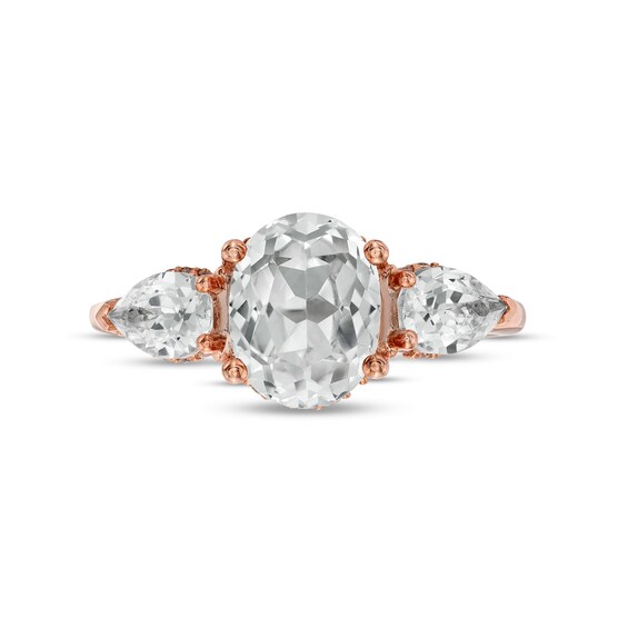 Oval White Lab-Created Sapphire and 1/6 CT. T.w. Diamond Frame Three Stone Engagement Ring in 10K Rose Gold