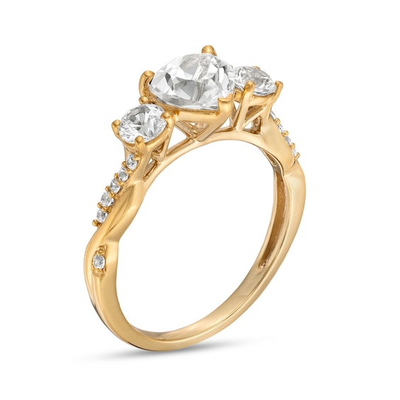 Heart-Shaped White Lab-Created Sapphire and 1/10 CT. T.w. Diamond Three Stone Twist Shank Engagement Ring in 10K Gold