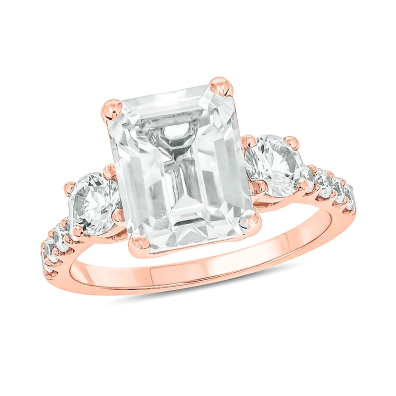 Main Image 1 of Emerald-Cut and Round White Lab-Created Sapphire and 1/5 CT. T.W. Diamond Three Stone Ring in 10K Rose Gold