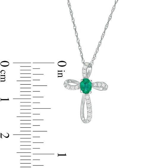 Oval Emerald and 1/10 CT. T.w. Diamond Pinwheel Cross Pendant in 10K White Gold