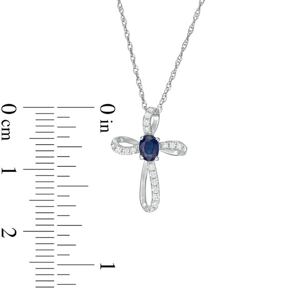 Oval Blue Sapphire and 1/10 CT. T.w. Diamond Pinwheel Cross Pendant in 10K White Gold