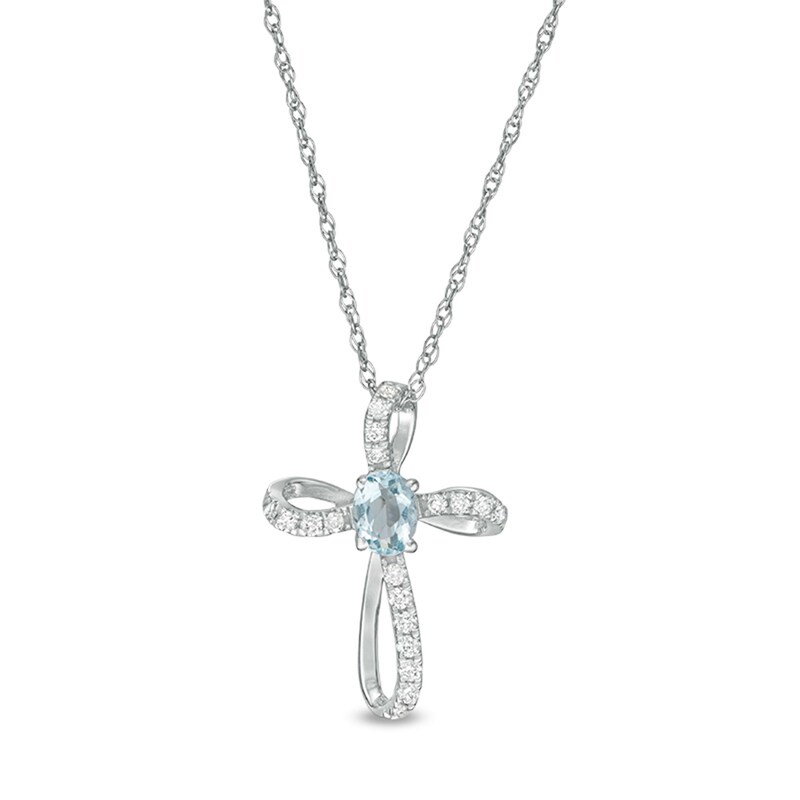 Main Image 1 of Oval Aquamarine and 1/10 CT. T.W. Diamond Pinwheel Cross Pendant in 10K White Gold