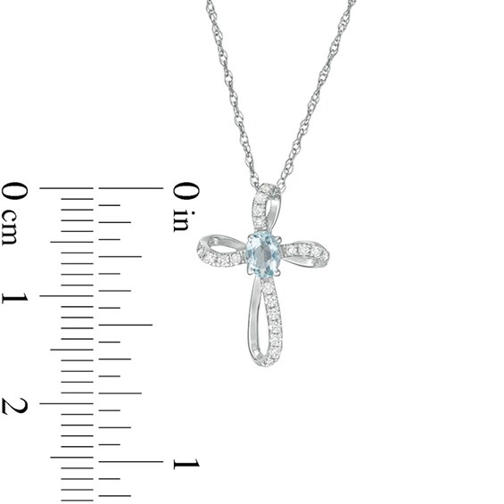 Oval Aquamarine and 1/10 CT. T.w. Diamond Pinwheel Cross Pendant in 10K White Gold