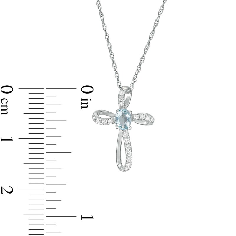 Main Image 2 of Oval Aquamarine and 1/10 CT. T.W. Diamond Pinwheel Cross Pendant in 10K White Gold