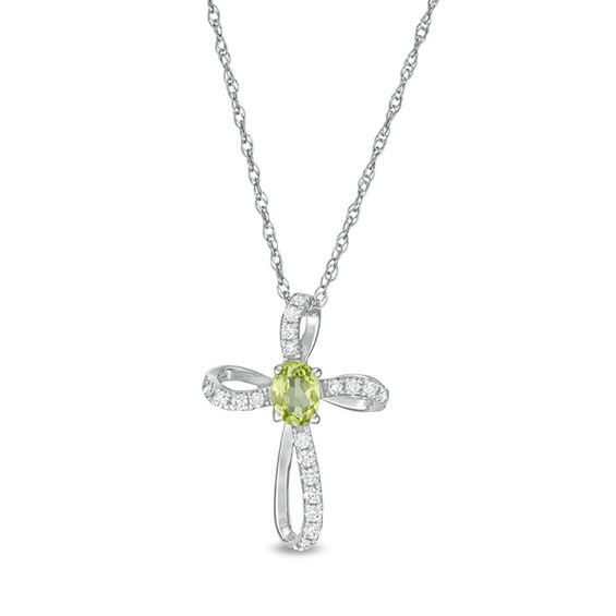 Oval Peridot and 1/10 CT. T.w. Diamond Pinwheel Cross Pendant in 10K White Gold