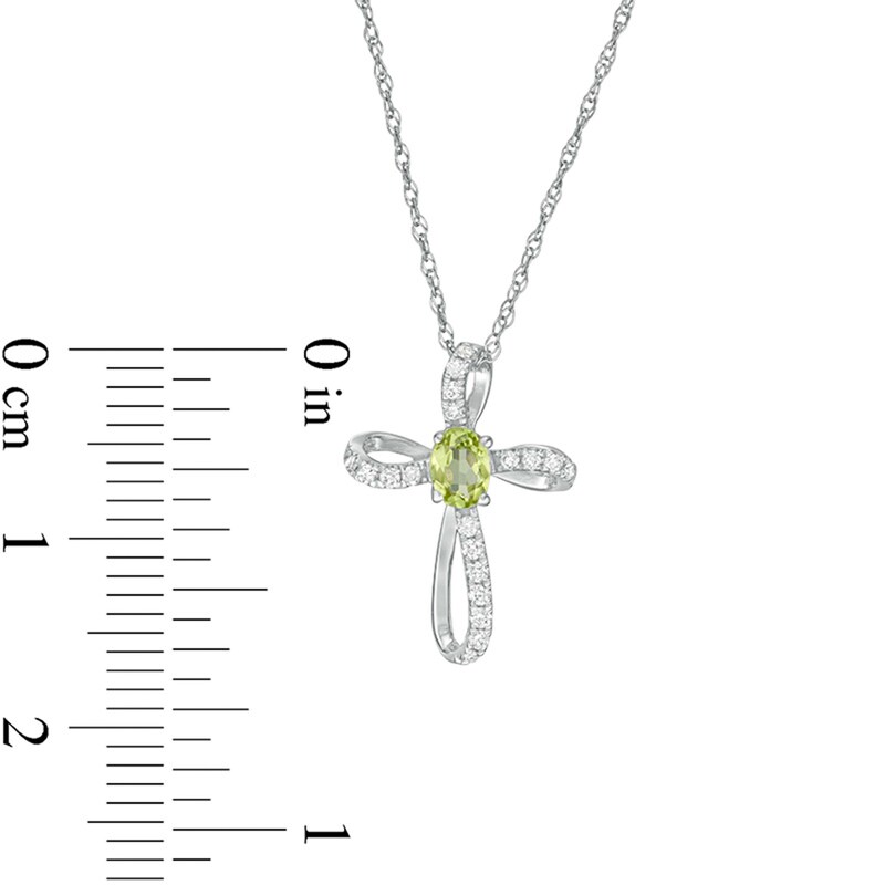 Main Image 2 of Oval Peridot and 1/10 CT. T.W. Diamond Pinwheel Cross Pendant in 10K White Gold