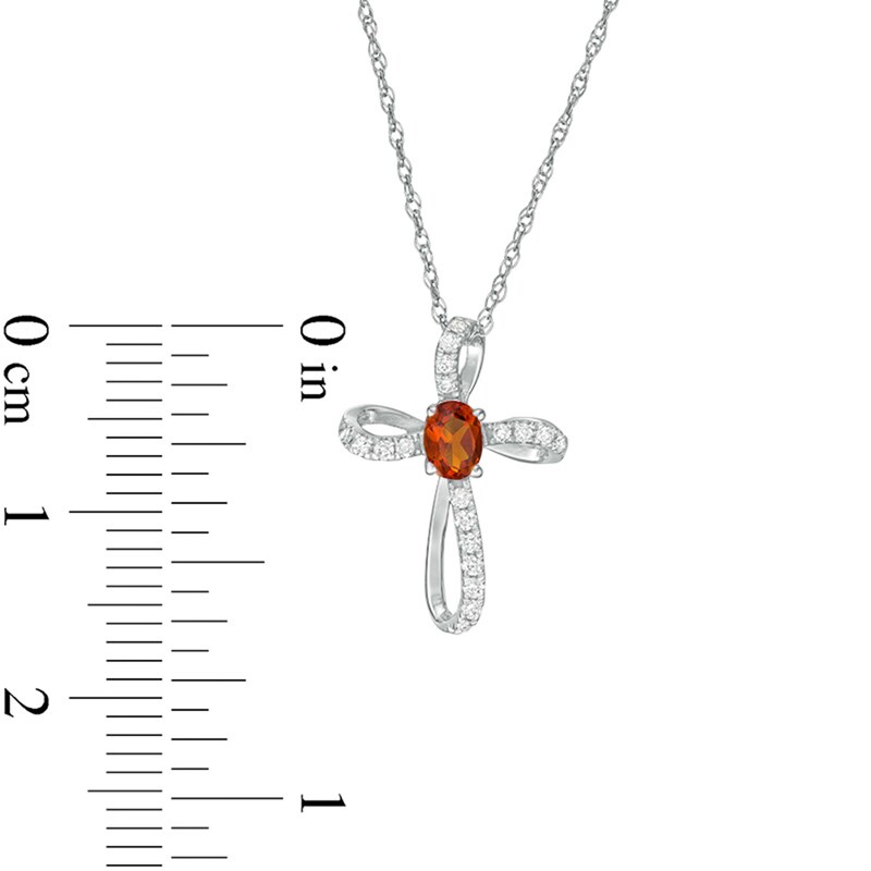 Main Image 2 of Oval Citrine and 1/10 CT. T.W. Diamond Pinwheel Cross Pendant in 10K White Gold