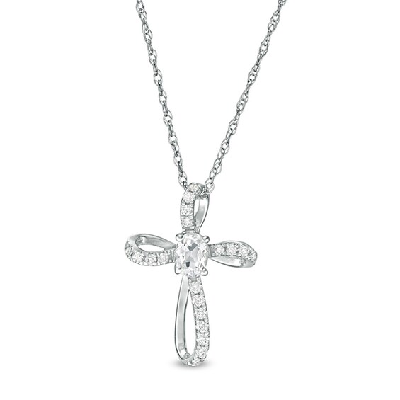 Oval White Topaz and 1/10 CT. T.w. Diamond Pinwheel Cross Pendant in 10K White Gold