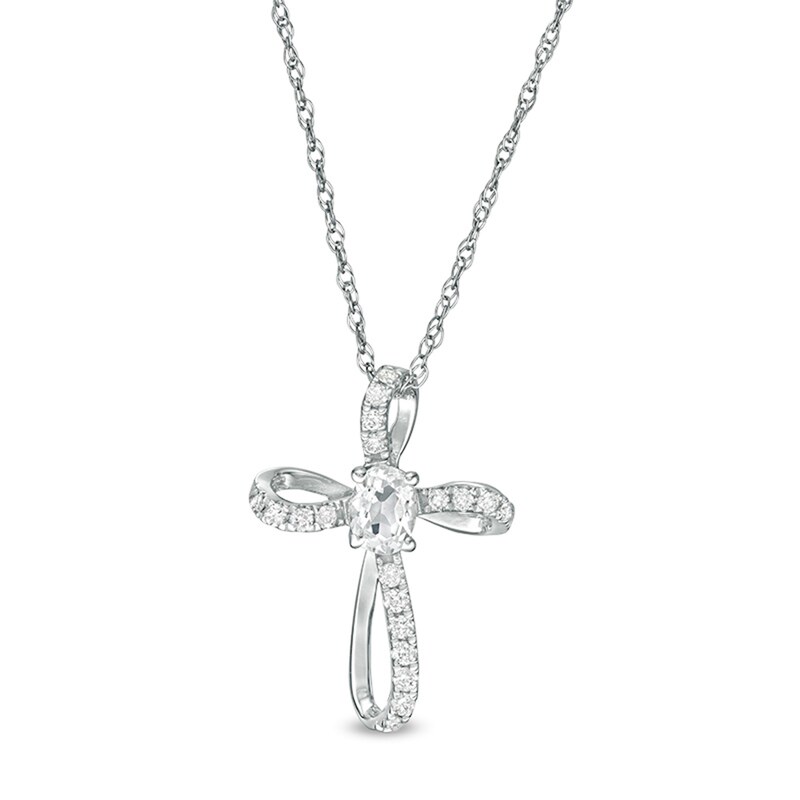 Main Image 1 of Oval White Topaz and 1/10 CT. T.W. Diamond Pinwheel Cross Pendant in 10K White Gold