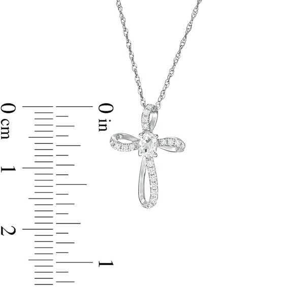 Oval White Topaz and 1/10 CT. T.w. Diamond Pinwheel Cross Pendant in 10K White Gold