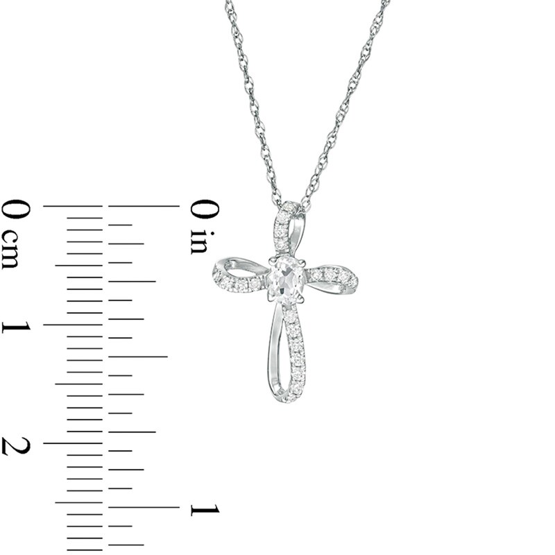 Main Image 2 of Oval White Topaz and 1/10 CT. T.W. Diamond Pinwheel Cross Pendant in 10K White Gold