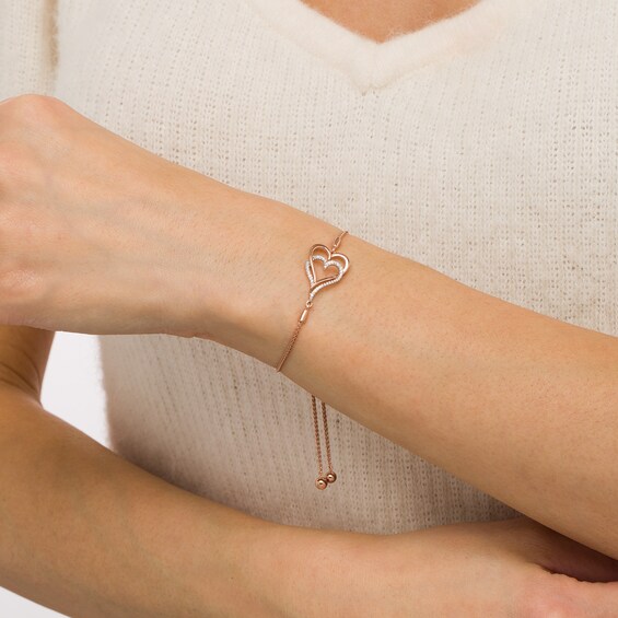 1/10 CT. T.w. Diamond Interlocking Double Elongated Heart Bolo Bracelet in Sterling Silver with 14K Rose Gold Plate