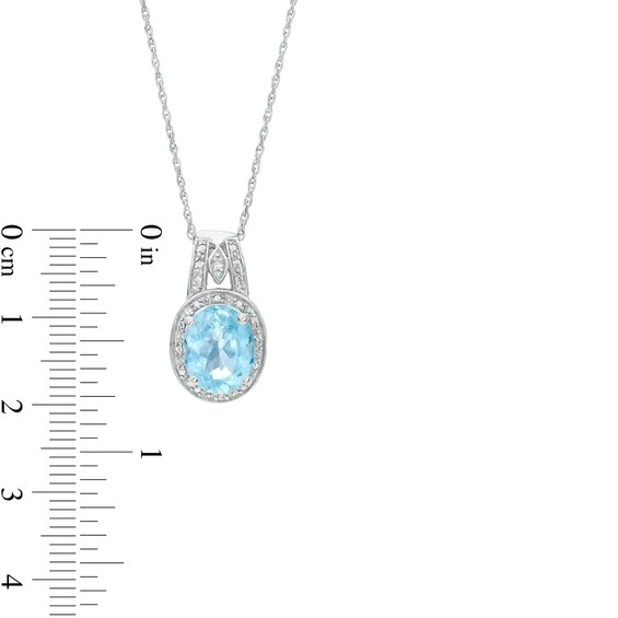 Oval Sky Blue Topaz and Diamond Accent Bead Frame Pendant in Sterling Silver