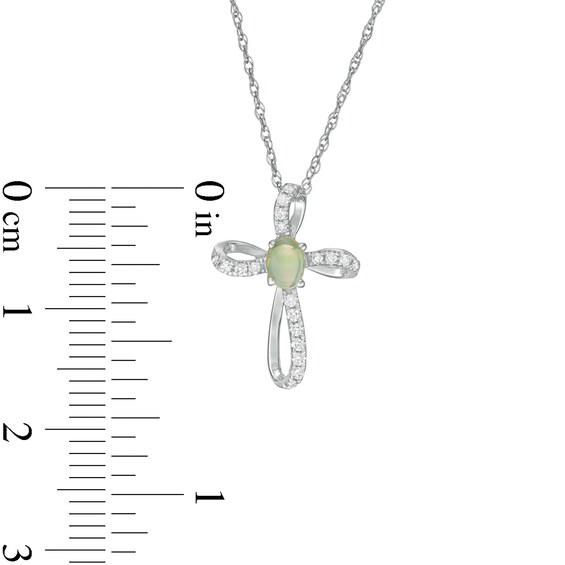 Oval Opal and 1/10 CT. T.w. Diamond Pinwheel Cross Pendant in 10K White Gold