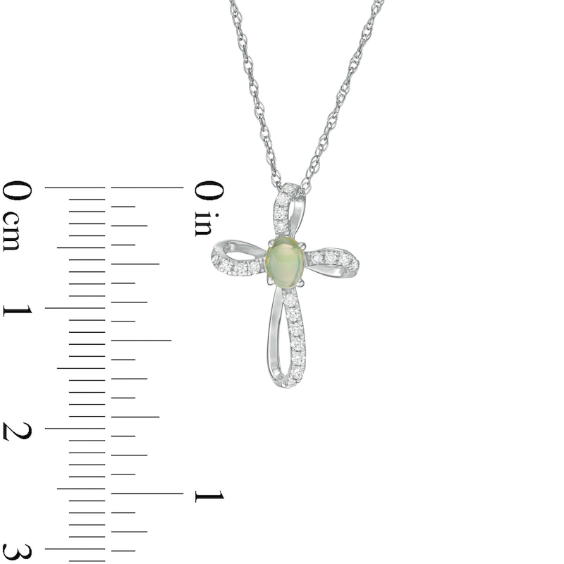 Oval Opal and 1/10 CT. T.W. Diamond Pinwheel Cross Pendant in 10K White ...