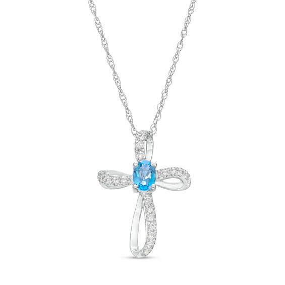 Oval Swiss Blue Topaz and 1/10 CT. T.w. Diamond Pinwheel Cross Pendant in 10K White Gold