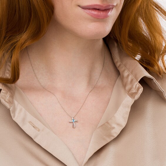 Oval Swiss Blue Topaz and 1/10 CT. T.w. Diamond Pinwheel Cross Pendant in 10K White Gold
