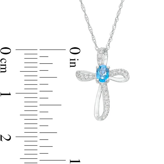 Oval Swiss Blue Topaz and 1/10 CT. T.w. Diamond Pinwheel Cross Pendant in 10K White Gold