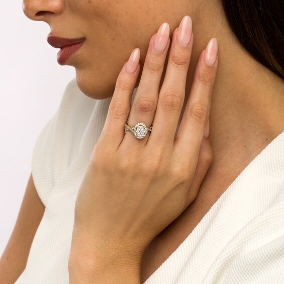 1/2 CT. T.w. Oval-Shape Multi-Diamond Frame Twist Shank Engagement Ring in 10K Gold