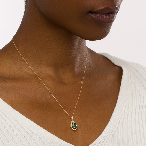 Oval Emerald and 1/6 CT. T.w. Diamond Open Frame Teardrop Pendant in 10K Gold