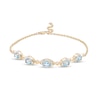 Thumbnail Image 1 of Oval Swiss Blue Topaz and Diamond Accent Twist Five Stone Bracelet in 10K Gold – 8.0"