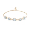 Thumbnail Image 0 of Oval Swiss Blue Topaz and Diamond Accent Twist Five Stone Bracelet in 10K Gold – 8.0"