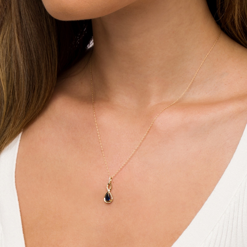 Main Image 2 of Pear-Shaped Blue Sapphire and 1/20 CT. T.W. Diamond Twist Pendant in 10K Gold