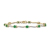 Thumbnail Image 0 of Oval Emerald and 1/6 CT. T.W. Diamond Wave Link Alternating Line Bracelet in 14K Gold – 7.25"