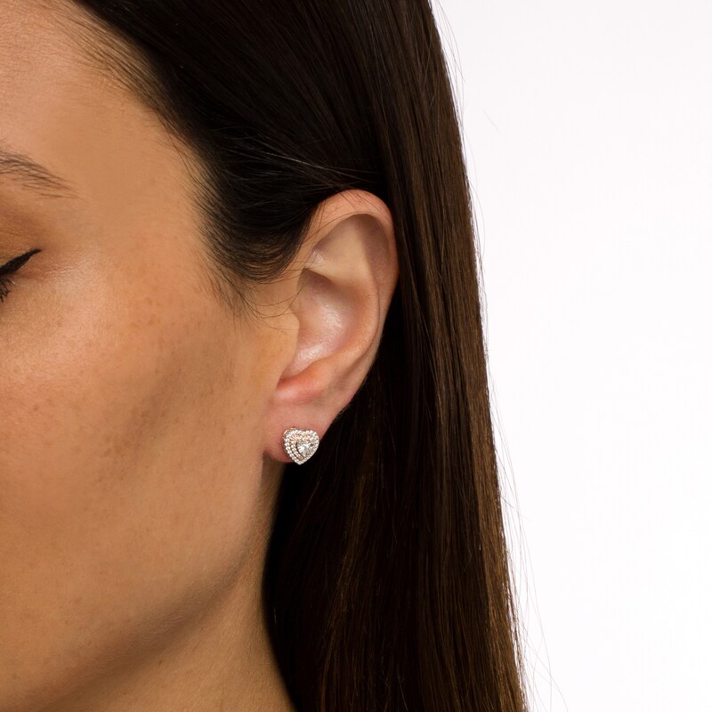 Main Image 2 of 1/6 CT. T.W. Diamond Double Heart-Shaped Frame Stud Earrings in Sterling Silver and 10K Rose Gold