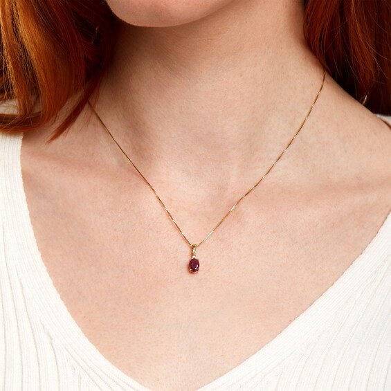 Oval Ruby and Diamond Accent Stacked Twist Bail Pendant in 10K Gold