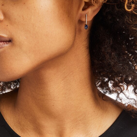 Oval Blue Sapphire and 1/15 CT. T.w. Diamond Drop Earrings in 10K Gold