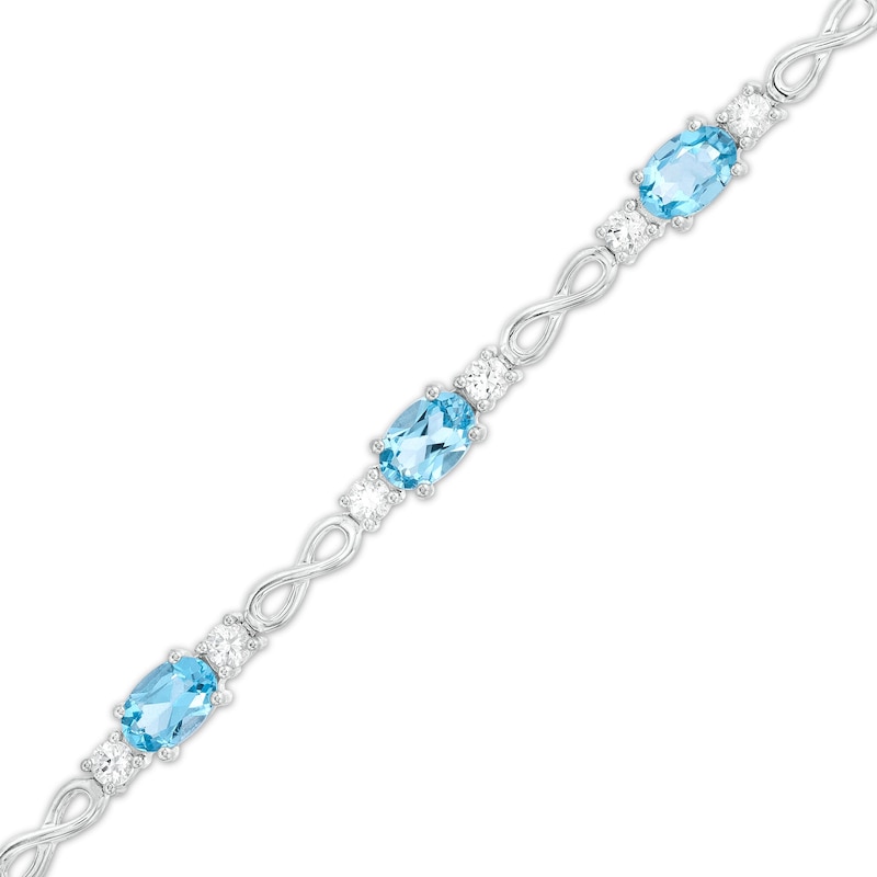 Main Image 1 of Oval Swiss Blue Topaz and White Lab-Created Sapphire Alternating Infinity Loop Link Bracelet in Sterling Silver – 7.25"