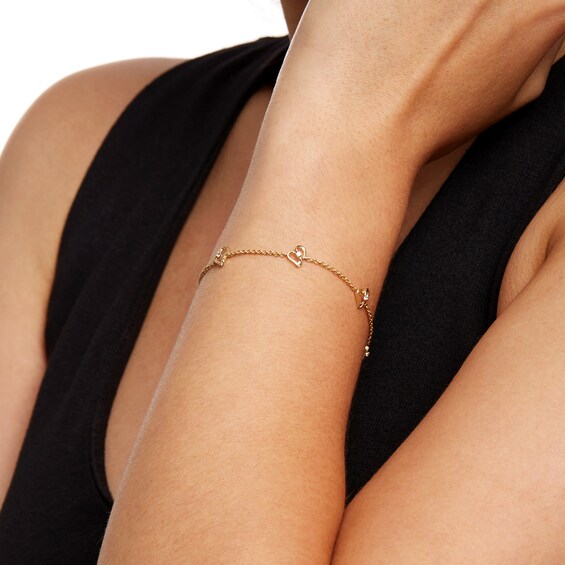 Two in Love 1/10 CT. T.w. Diamond Tilted Loop Heart Station Bracelet in 10K Gold â 7.5"