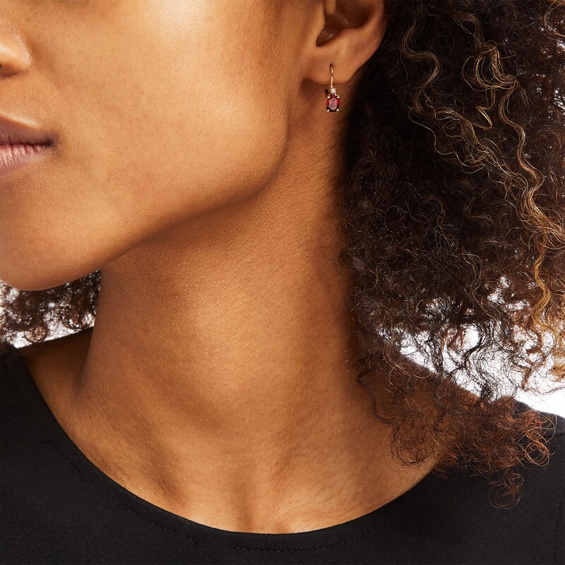 Main Image 2 of Oval Garnet and 1/20 CT. T.W. Diamond Drop Earrings in 10K Gold