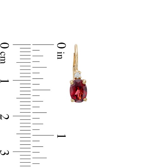 Oval Garnet and 1/20 CT. T.w. Diamond Drop Earrings in 10K Gold