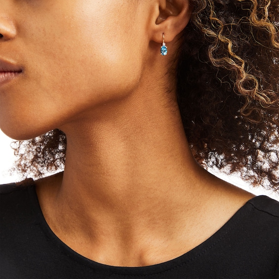 Oval Swiss Blue Topaz and 1/20 CT. T.w. Diamond Drop Earrings in 10K Gold