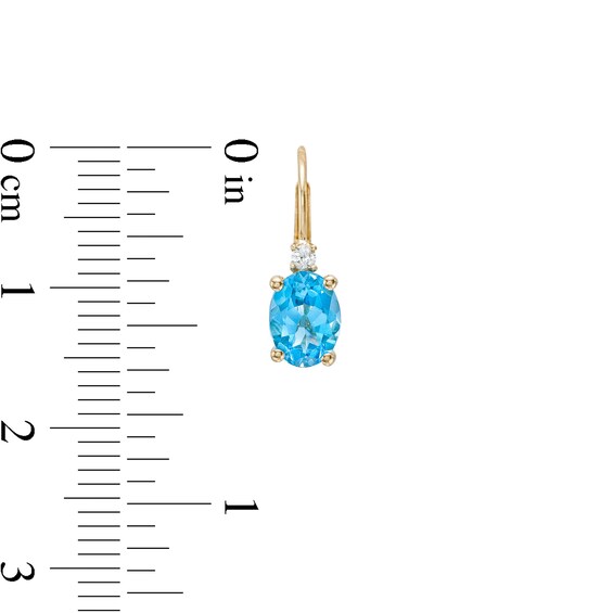 Oval Swiss Blue Topaz and 1/20 CT. T.w. Diamond Drop Earrings in 10K Gold