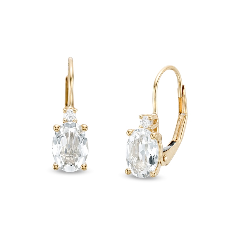 Oval White Topaz and 1/20 CT. T.W. Diamond Drop Earrings in 10K Gold