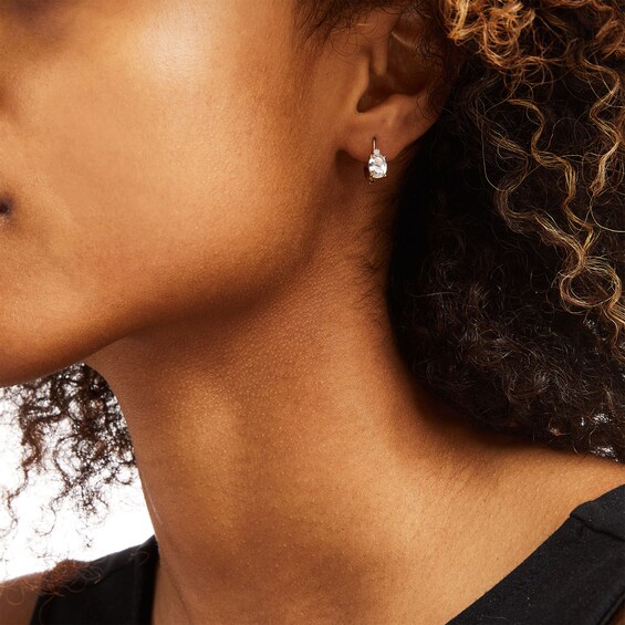 Oval White Topaz and 1/20 CT. T.w. Diamond Drop Earrings in 10K Gold