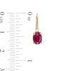 Oval Ruby and 1/20 CT. T.W. Diamond Drop Earrings in 10K Gold