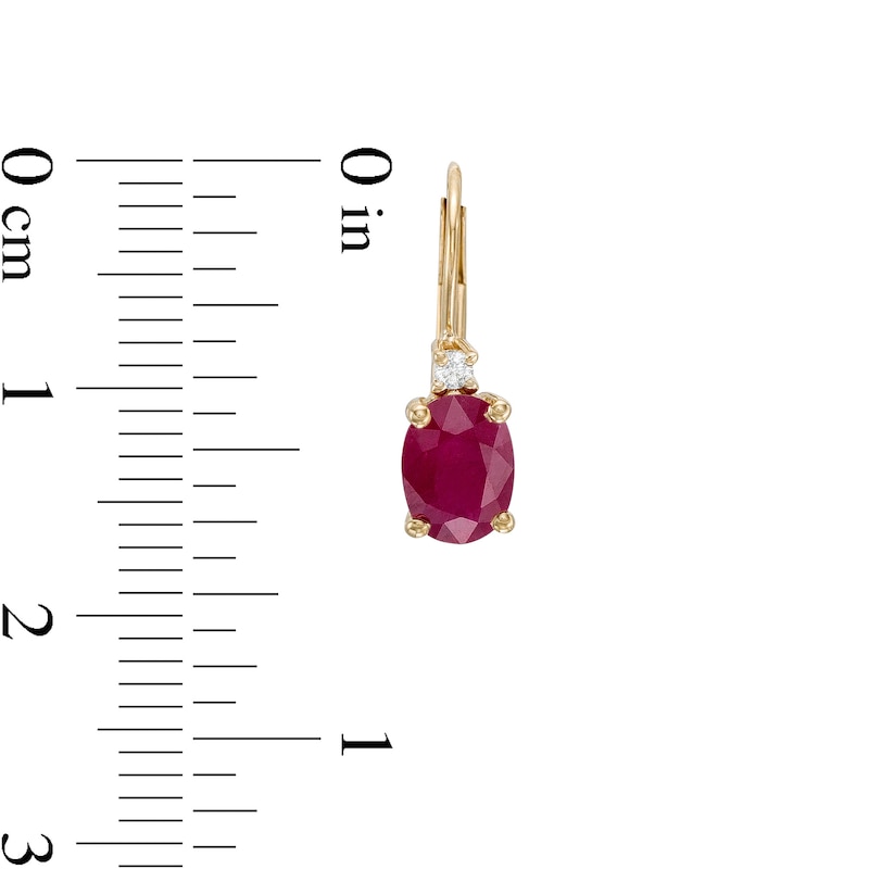 Oval Ruby and 1/20 CT. T.W. Diamond Drop Earrings in 10K Gold