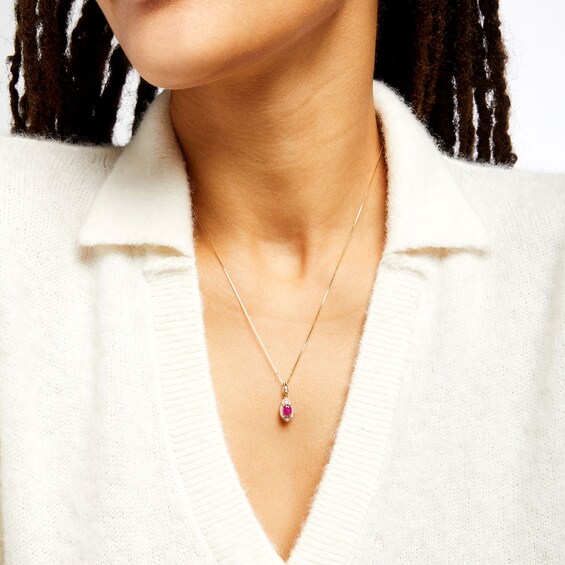Oval Ruby and 1/6 CT. T.w. Diamond Frame Pendant in 10K Gold