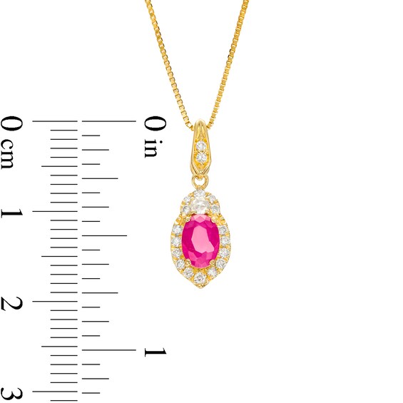 Oval Ruby and 1/6 CT. T.w. Diamond Frame Pendant in 10K Gold