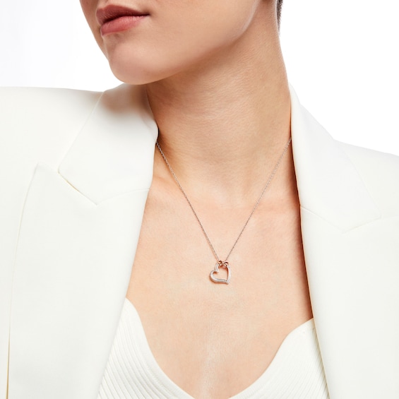 1/20 CT. T.w. Diamond Beaded Bow Tied Tilted Heart Pendant in Sterling Silver and 10K Rose Gold