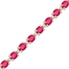 Thumbnail Image 1 of Oval Ruby and 1/6 CT. T.W. Diamond Alternating Line Bracelet in 10K Gold